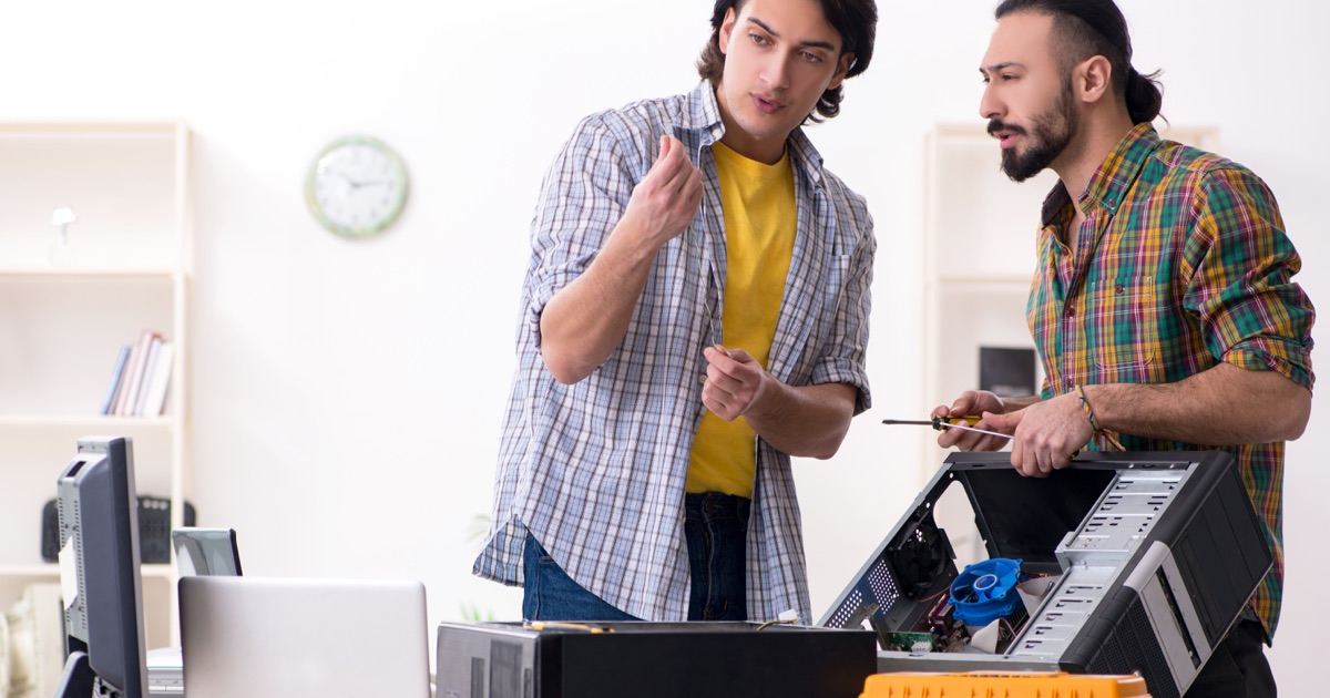 IT technicians troubleshooting a computer integration problem