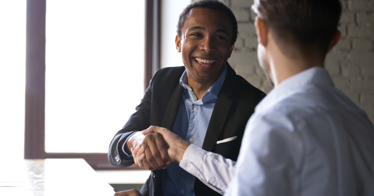 Business professionals shaking hands after selecting a Business Central partner