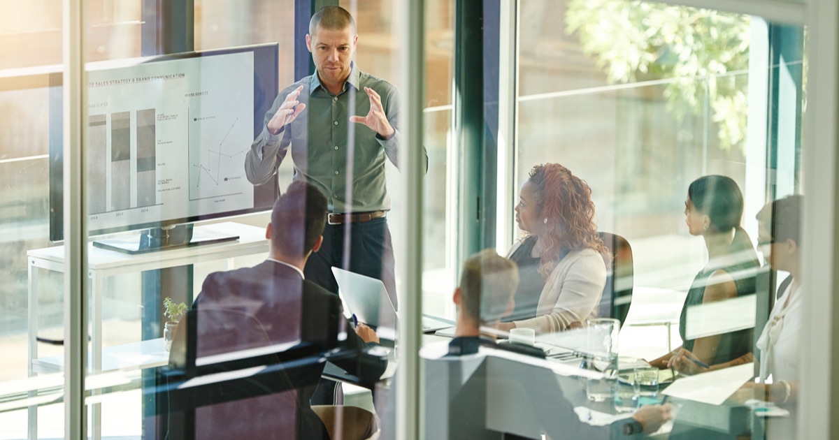 Business leader presenting company data and reporting to a management team