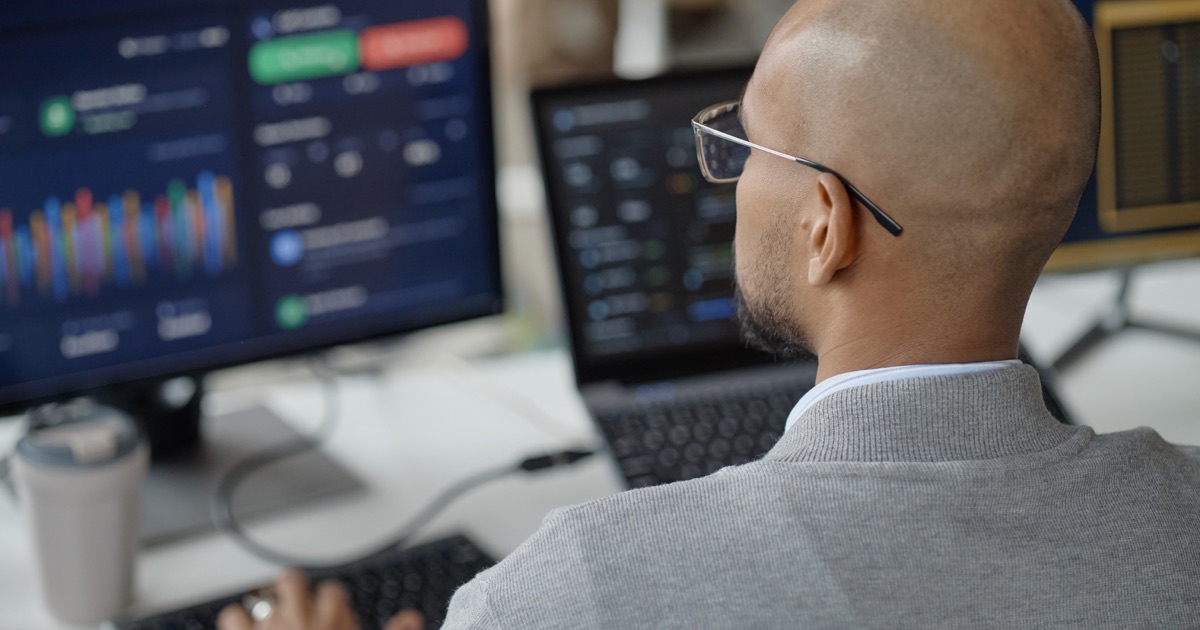 IT specialist monitoring integration logs and system performance dashboards