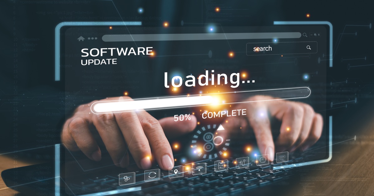 Developer monitoring a website software update and loading performance on a laptop