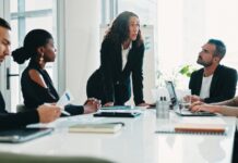 When Is It Time to Move From QuickBooks to Business Central Finance team discussing accounting reports during a software migration
