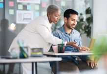 Website Redesign Readiness Checklist for ERP-Focused Businesses Business team reviewing a website redesign on a laptop for an ERP-focused company